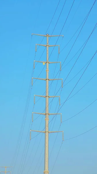 high voltage power lines on blue sky background