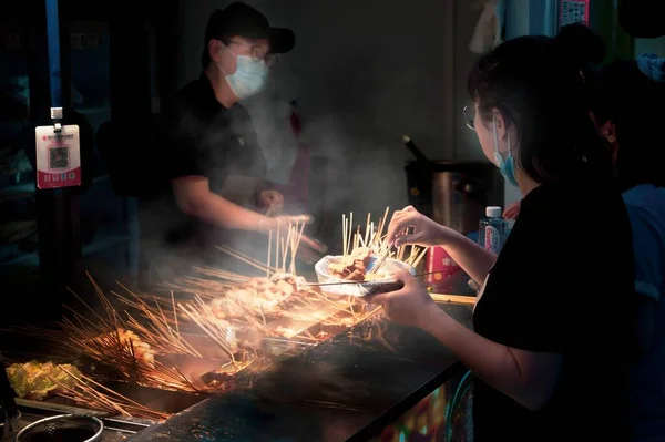 a man is preparing a fire in the kitchen.