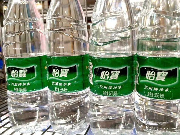 green and white plastic bottles with different colors