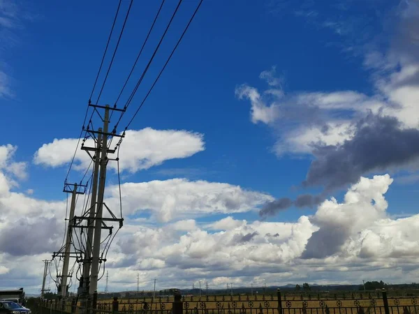 high voltage power line against the blue sky