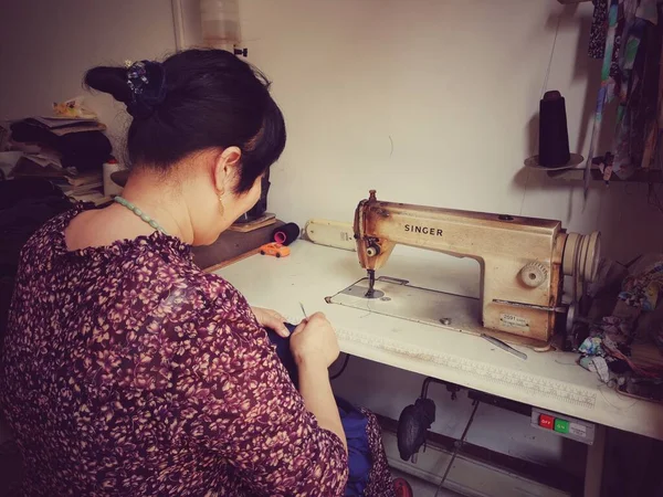 woman sewing machine with a tattoo