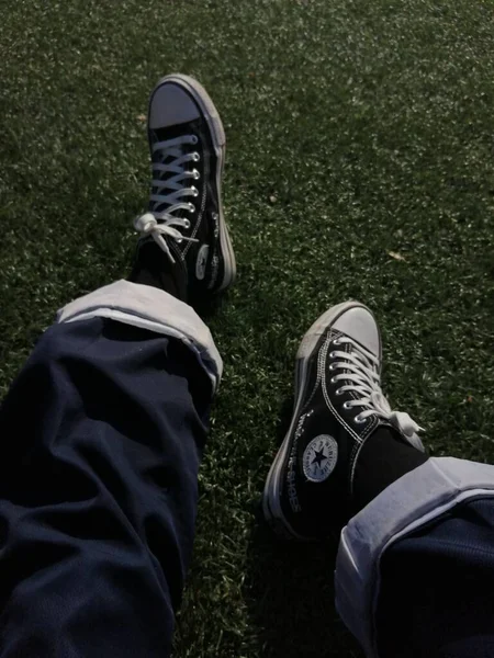 man\'s feet on the grass