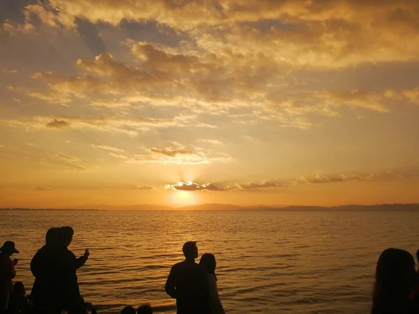 silhouette of a man and woman on the beach