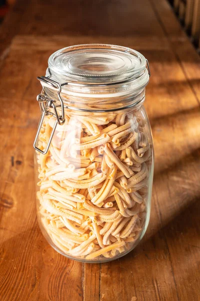 pasta in glass jar on wooden background