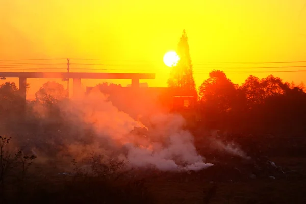 smoke from the chimney of the city of the setting sun