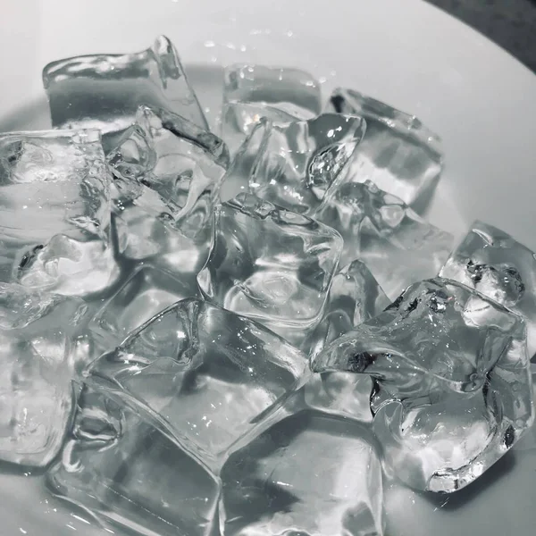 ice cubes with water drops on white background