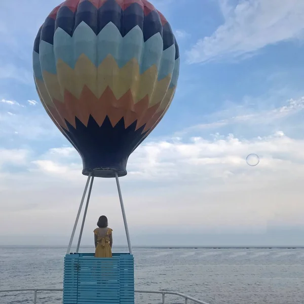 a man with a balloon in the sky