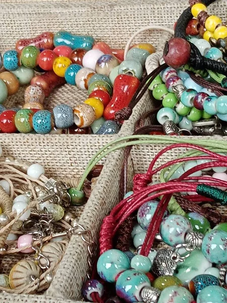 colorful beads on the background of the old wooden table