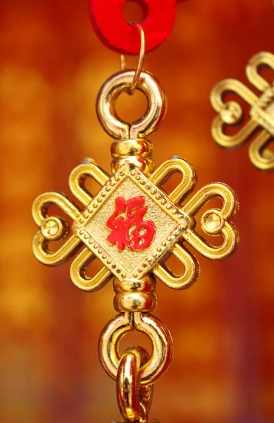 golden earrings with gold and silver beads on a red background
