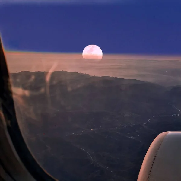 view of the sky and the moon in the mountains