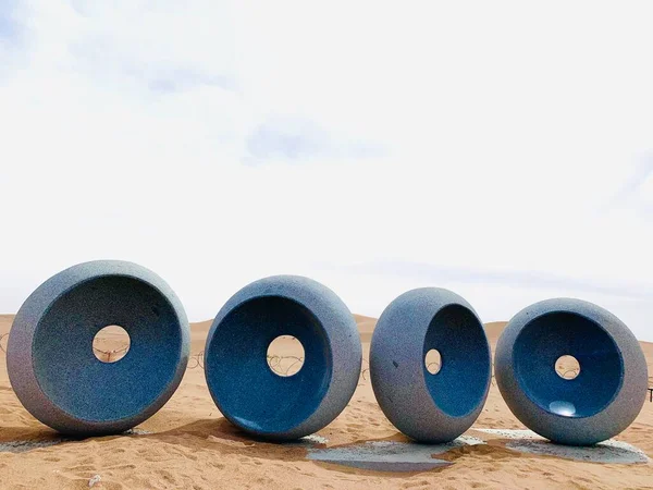 stack of different colored metal pipes on the background of the blue sky