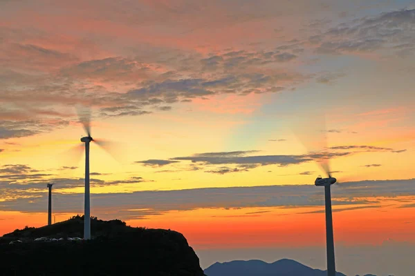 wind turbines on sunset sky background