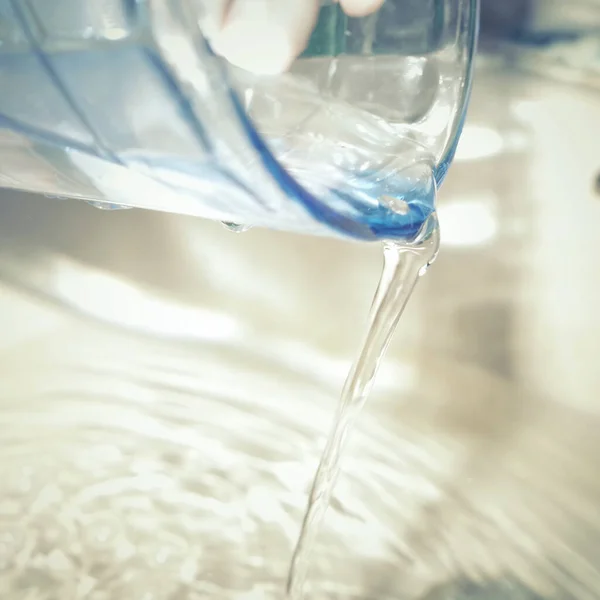 water pouring into a glass