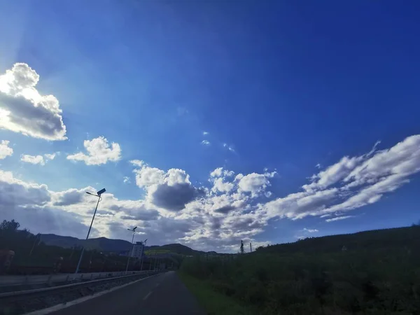 beautiful landscape with a road and a blue sky