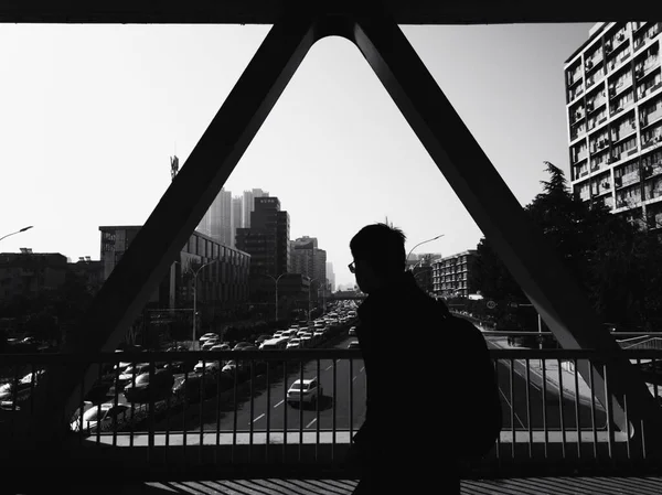 silhouette of a man in a black suit and a white shirt on the roof of the city