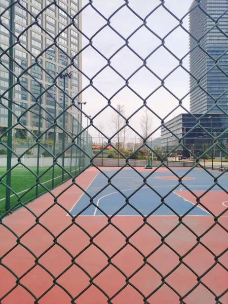 a vertical shot of a fence with a net