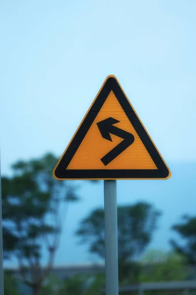 road sign with a warning symbol