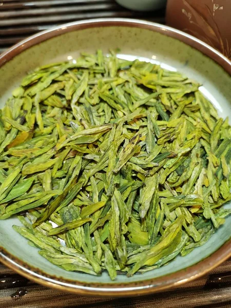 dried green tea leaves in a bowl