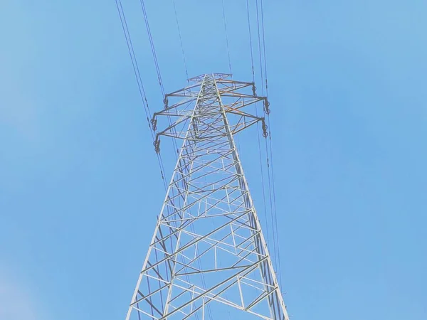 high voltage power line against blue sky