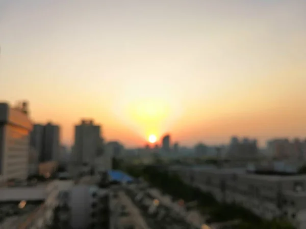blurred city skyline with sunset