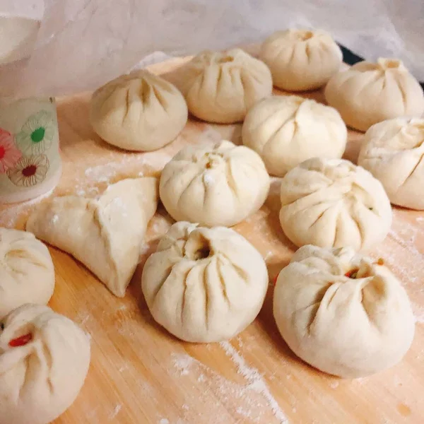 raw dumplings on a wooden table