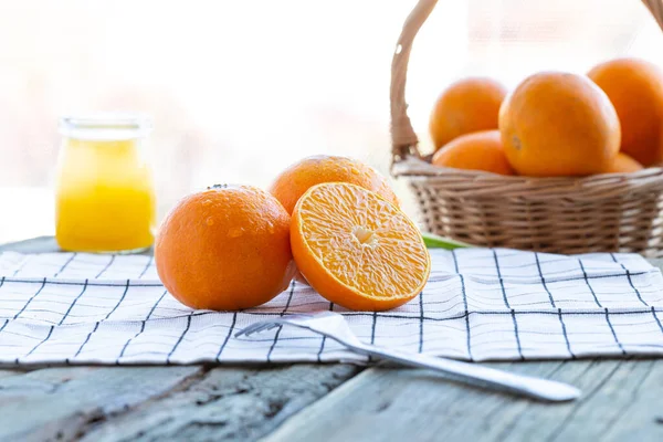 fresh orange juice and oranges on white background