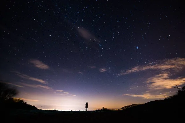 silhouette of a woman on a background of the starry sky