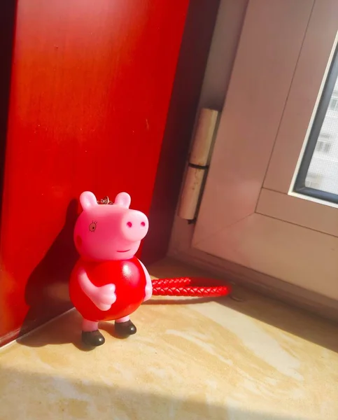 red piggy bank with a pig toy