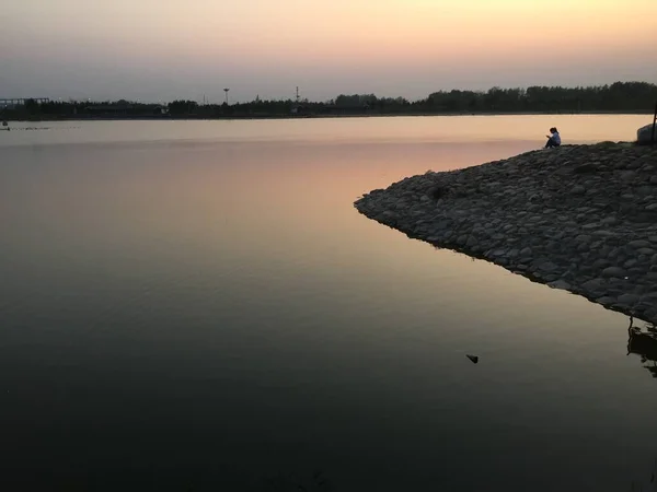 silhouette of a man on the lake