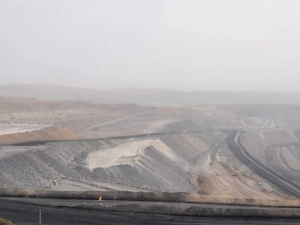 a large pile of coal mining in the desert