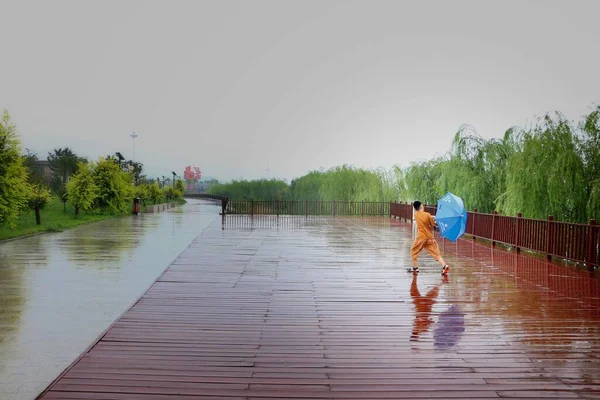 young couple walking on the pier in the park