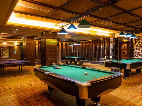 billiard table with pool and balls