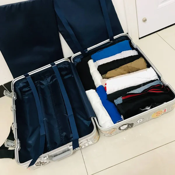 luggage with a suitcase and a bag of clothes