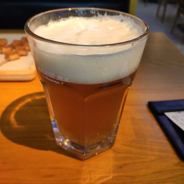 glass of beer with ice and a cup of coffee