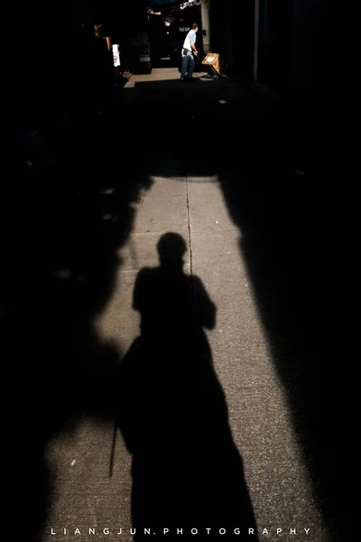 silhouette of a man in a black dress with a blurred background