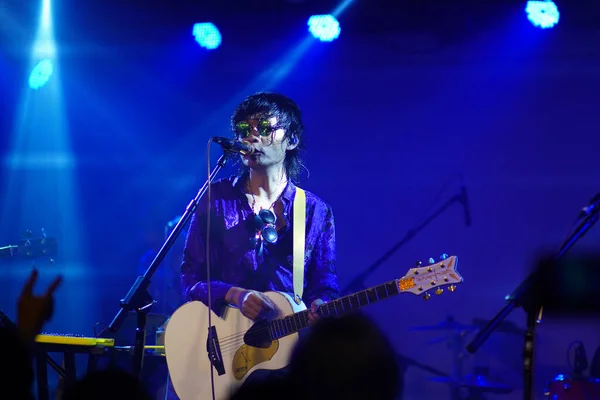 young man playing music with microphone