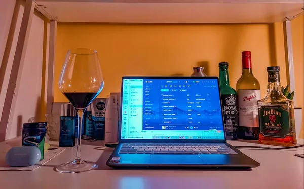 modern glass interior with red wine and a laptop