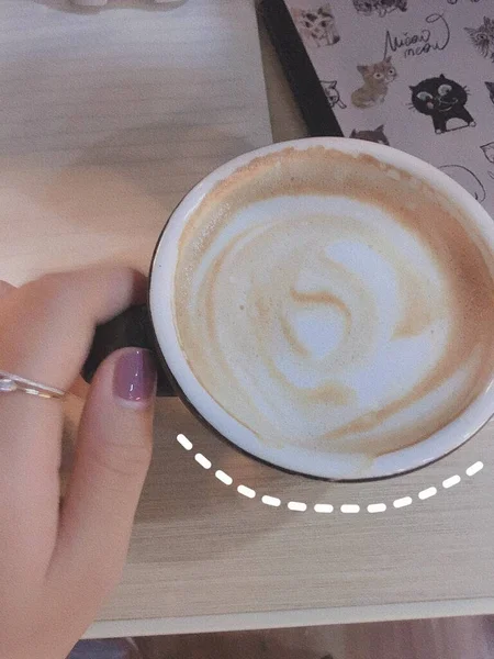 coffee cup with latte art on the table