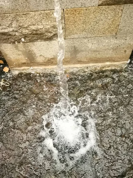 old stone wall with water drops