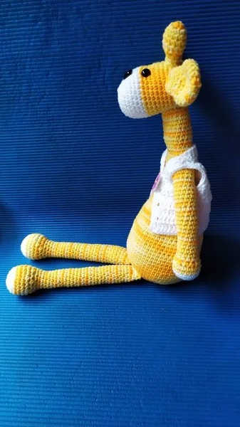 handmade knitted toy on a blue background