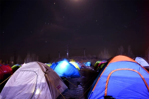 camping tent with tents on the background of the night sky