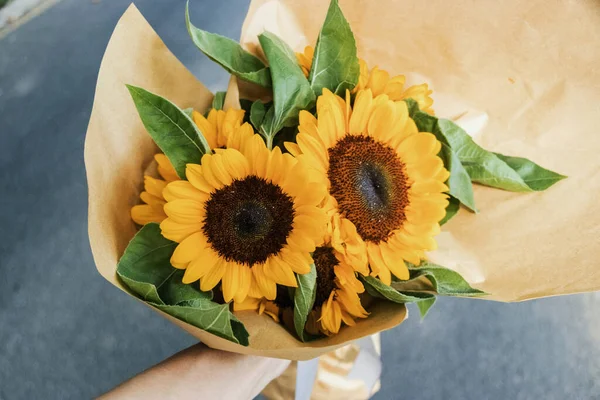 beautiful bouquet of sunflowers in a vase on a gray background