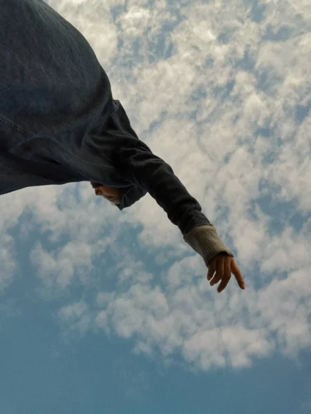 man with a hand on the sky