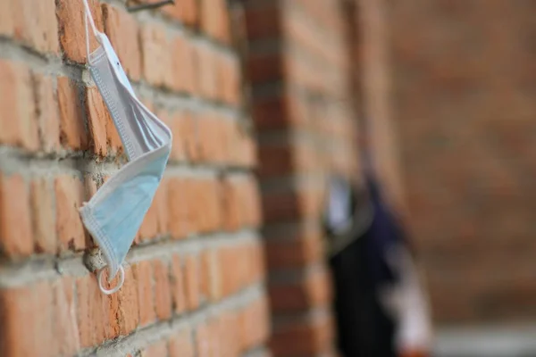 close up of a brick wall with a protective mask