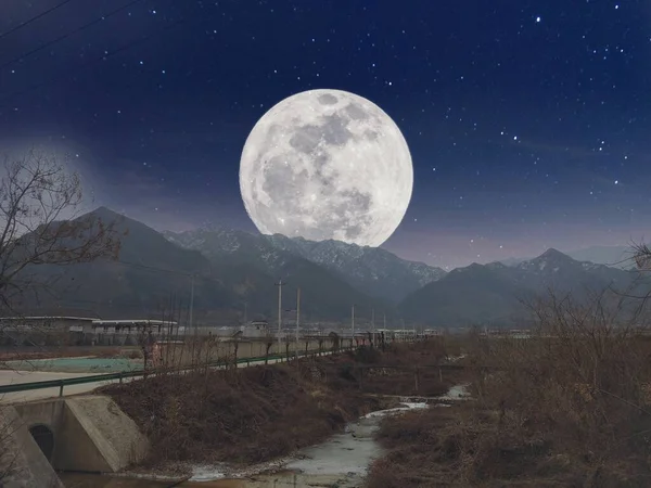 night view of the moon in the mountains