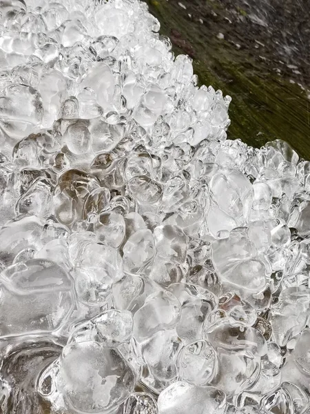 ice cube with water drops on the beach