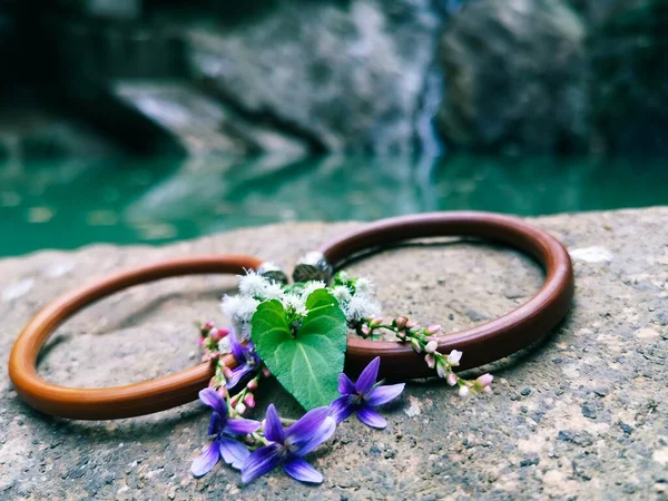 beautiful jewelry with flowers on wooden background