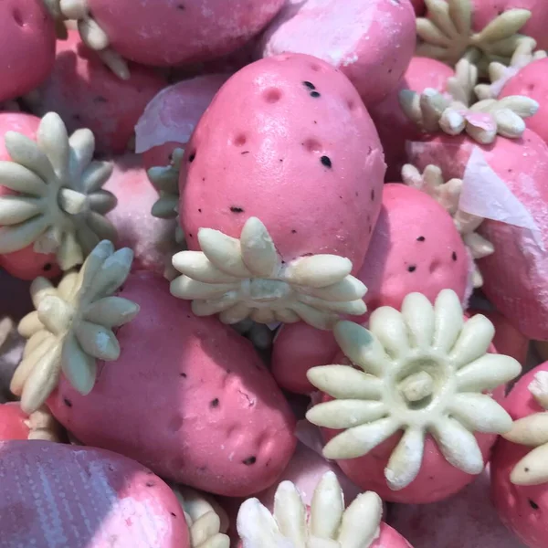 close up of a white and pink cake