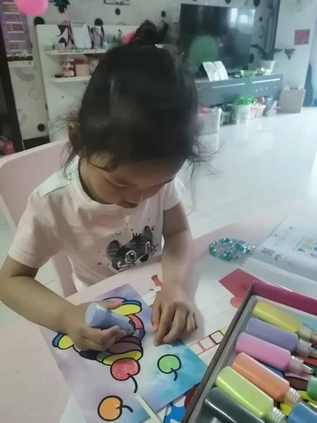 little girl with a tattoo on the table