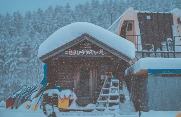 a small house in the snow